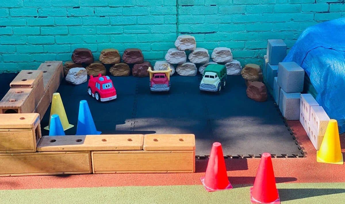Blooming Years Nursery Wimbledon - outdoor play area with toys and climbing equipment